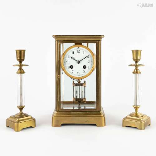 A three-piece mantle garniture clock and candlesticks. 19th ...