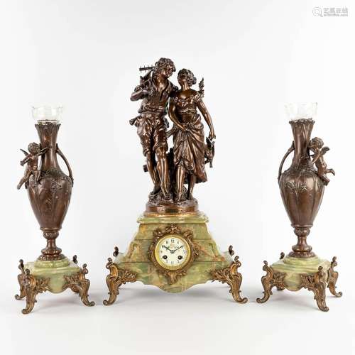 A three-piece mantle garniture clock with side pieces, spelt...