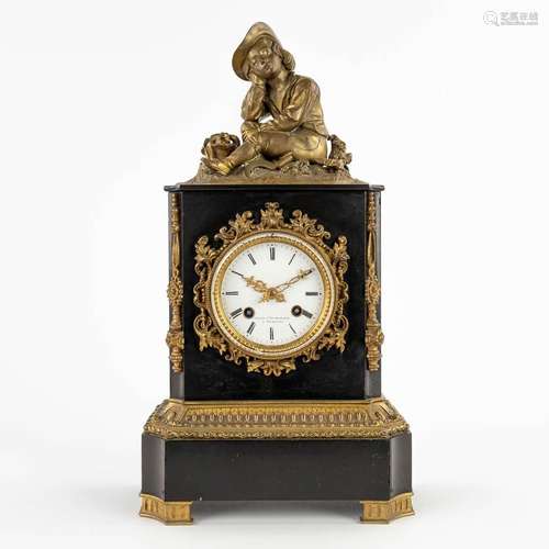 A mantle clock, black marble with a bronze figurine. 19th C....