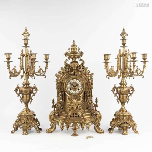 A three-piece mantle garniture consisting of a clock with ca...