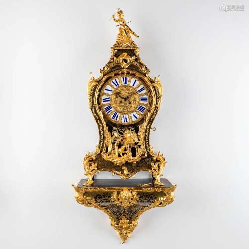 A boulle Cartel clock on a console, tortoiseshell and copper...