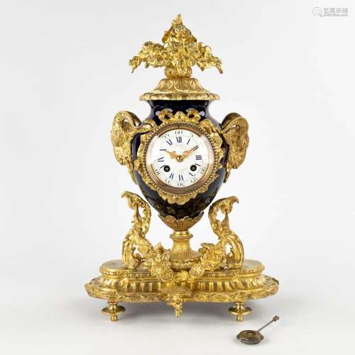 A mantle clock, gold-plated bronze on porcelain, finished wi...