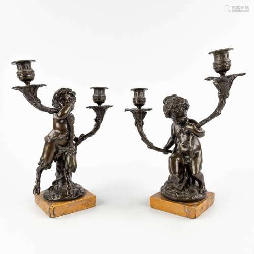 A pair of candelabra, 'Putti and a Faun', patinated bronze o...
