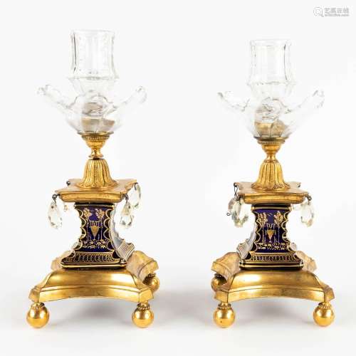 A pair of candlesticks, bronze finished with glass and porce...
