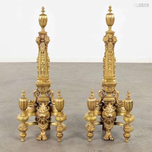 A pair of fireplace bucks, gilt bronze decorated with lion's...