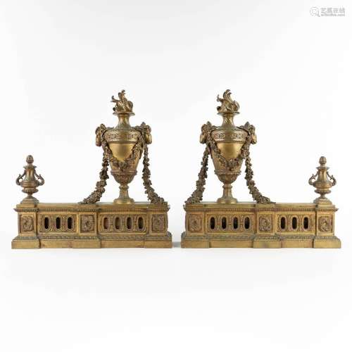 A pair of fireplace bucks, bronze in Louis XVI style and dec...