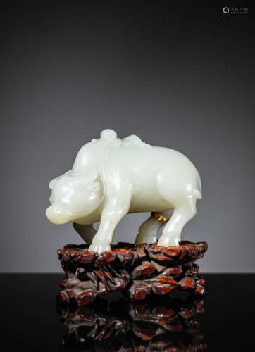 A Carved White Jade Figure And Bull