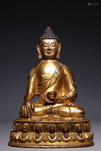 Qing Dynasty, a gilt-bronze figure of Sakyamuni with chisele...