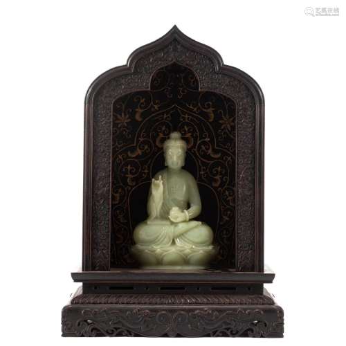 A CHINESE CARVED JADE BUDDHA WITH WOODEN NICHE