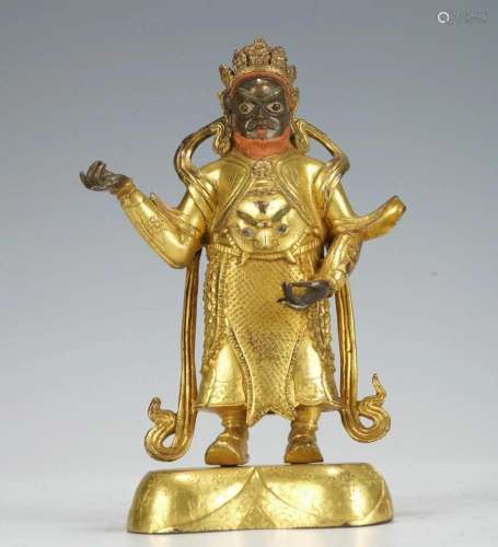 A CHINESE BRONZE-GILT STANDING GUARDIAN