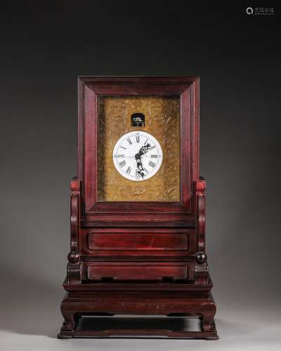 A rosewood mechanical clock