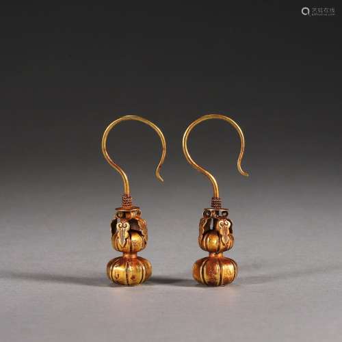 A pair of gourd shaped gold earrings