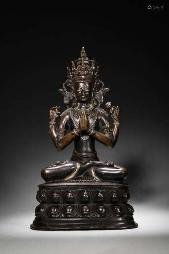 A silver-inlaid copper four-armed Guanyin bodhisattva statue
