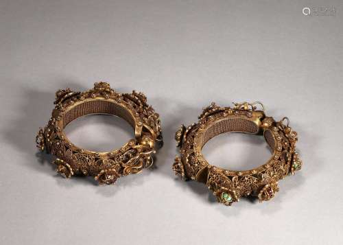 A pair of dragon patterned gilding silver bracelets
