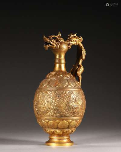 A gold pot with dragon shaped handle