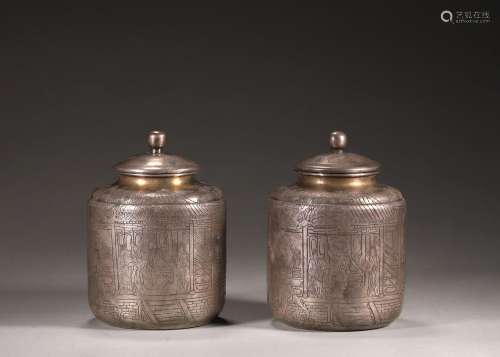 A pair of figure patterned silver jars