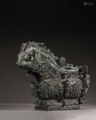 A taotie patterned bronze goat head pot