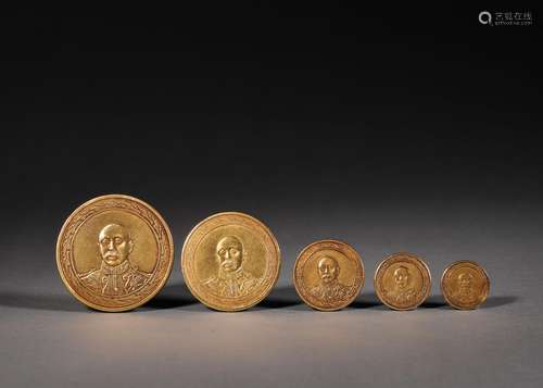 A set of 5 figure patterned gold coins