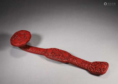 A figure and eight treasures carved red lacquer ruyi