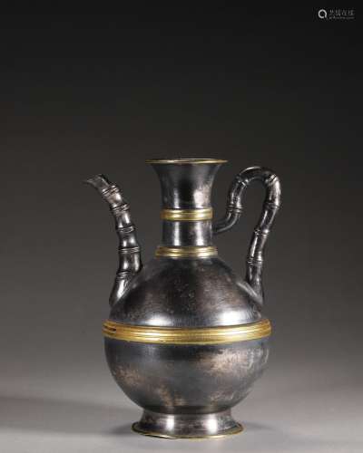 A silver pot with bamboo shaped handle