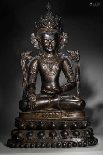 A silver-inlaid copper Vairocana statue