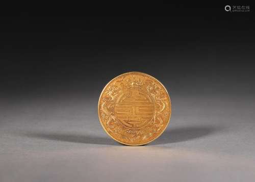 An inscribed dragon patterned gold coin