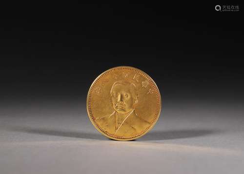 A figure patterned gold coin