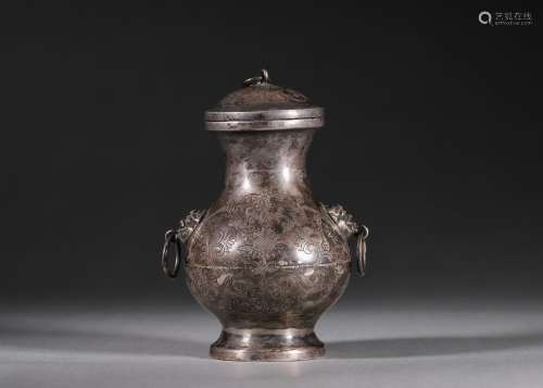 An interlocking flower patterned silver pot