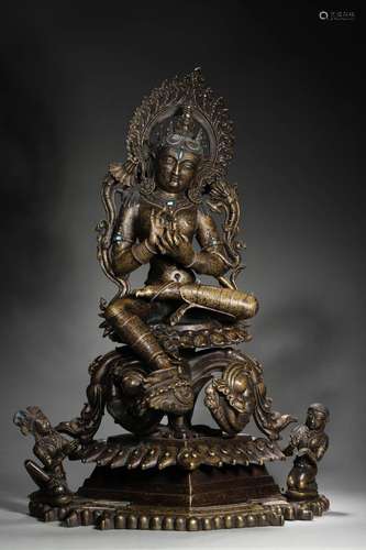 A silver-inlaid copper green tara statue