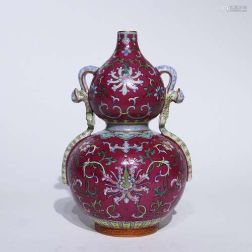 A red ground famille-rose 'floral' gourd-shaped vase