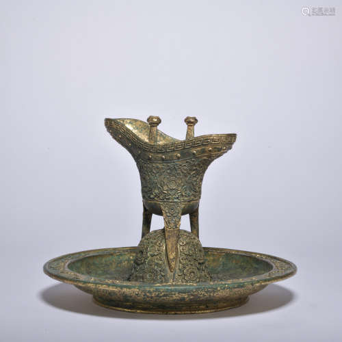 A bronze cup and holder