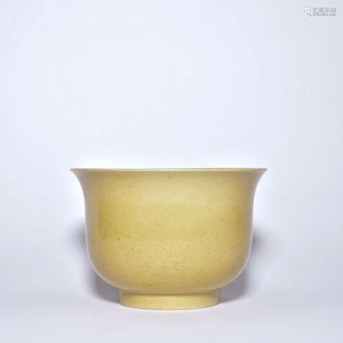 A yellow glazed cup