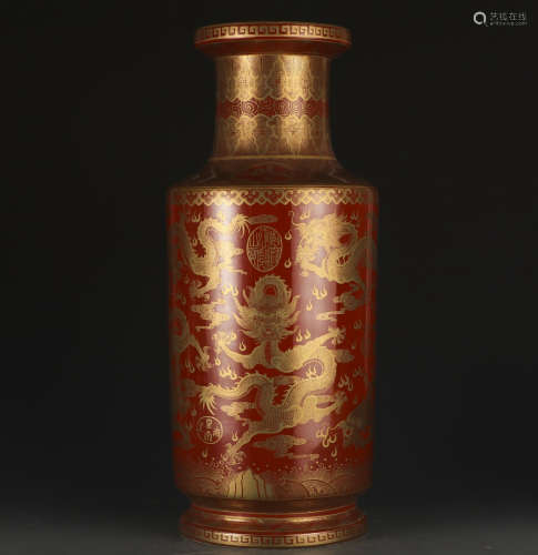 A red glazed 'dragon' vase painting in gold