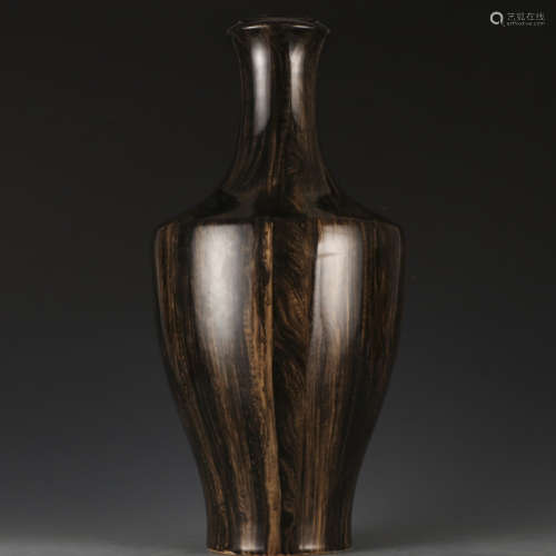 A wooden glazed vase