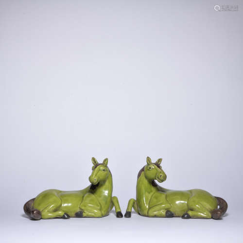 A pair of green glazed horse