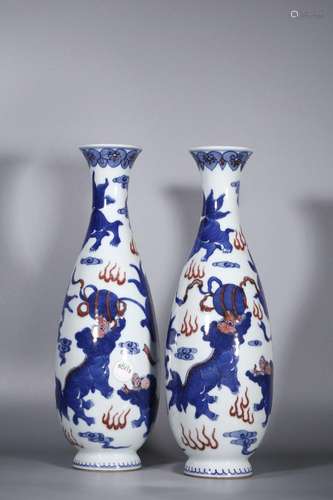 A pair of blue and white underglaze red lion playing ball sk...