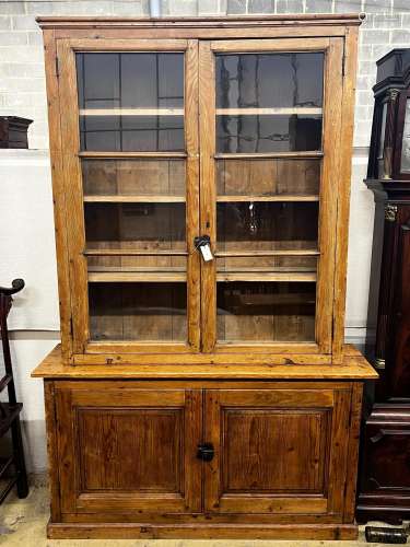 A 19th century French provincial pine two door glazed bookca...
