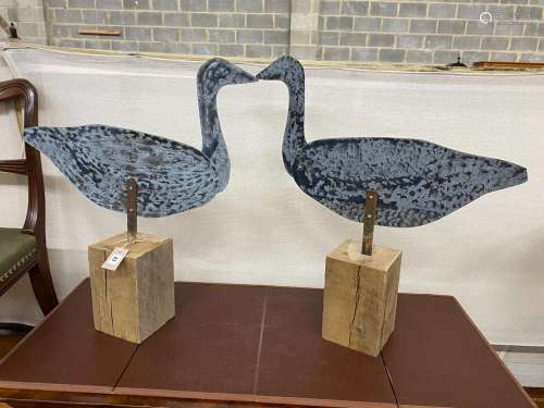 A pair of white metal decoy geese, with articulated necks, w...