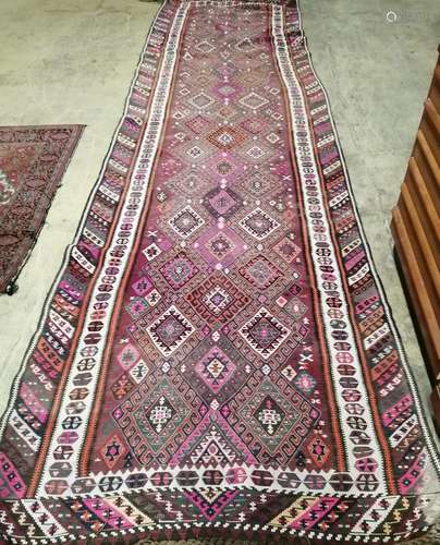 A polychrome Kilim flatweave runner, 434 x 124cm