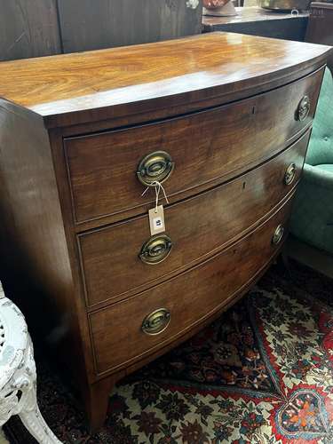 A Regency mahogany bow fronted chest of three long graduated...