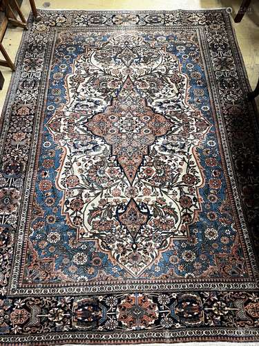 An antique Kashan blue ground rug, 207 x 140cm