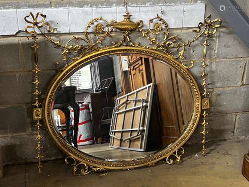 An Edwardian Sheraton revival oval giltwood and composition ...