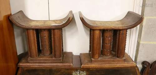 A pair of African carved hardwood stools, width 46cm, depth ...