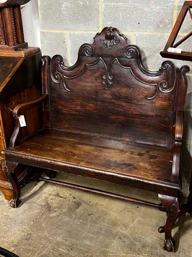 A Portuguese carved oak and fruitwood settle