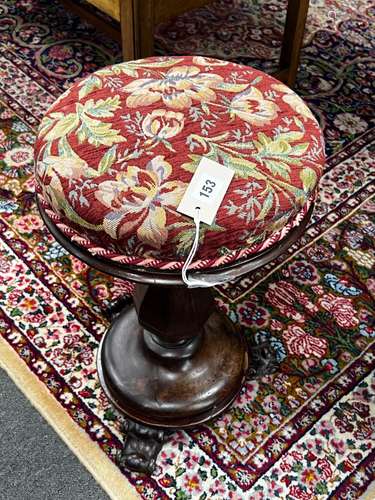 An early Victorian mahogany revolving piano stool