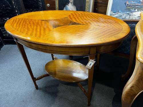 An Edwardian satinwood banded oval satinwood two tier centre...