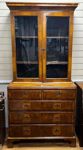 A Queen Anne revival feather banded walnut cabinet on chest,...