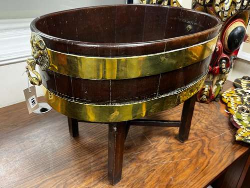 A George III brass bound oval mahogany wine cooler, with twi...