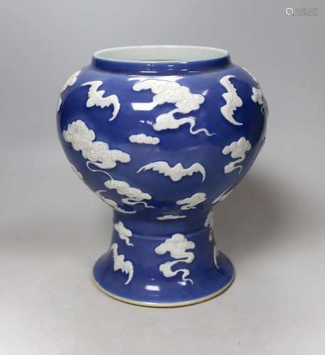 A Chinese slip-decorated blue glazed bats vase 24cm