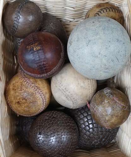 A collection of leather cricket and sporting balls